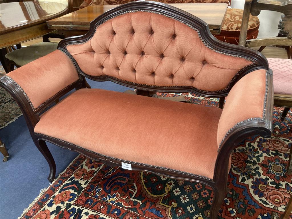 A mahogany framed two seater settee, with pink buttoned upholstery, c.1890, length 110cm, depth 42cm, height 86cm